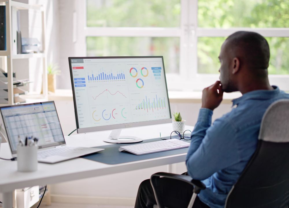 Marketing professional at desk looking at performance reports