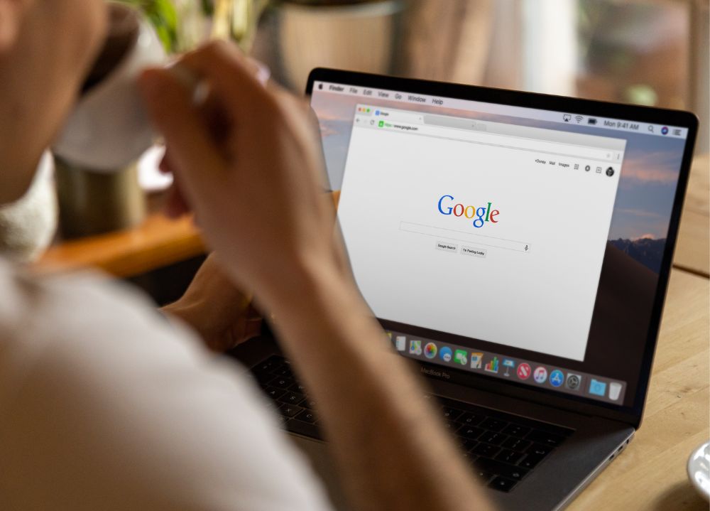 Person drinking coffee browsing on Google